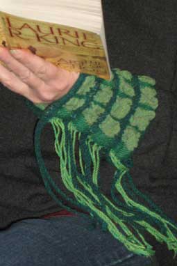 green fringed wrist warmer